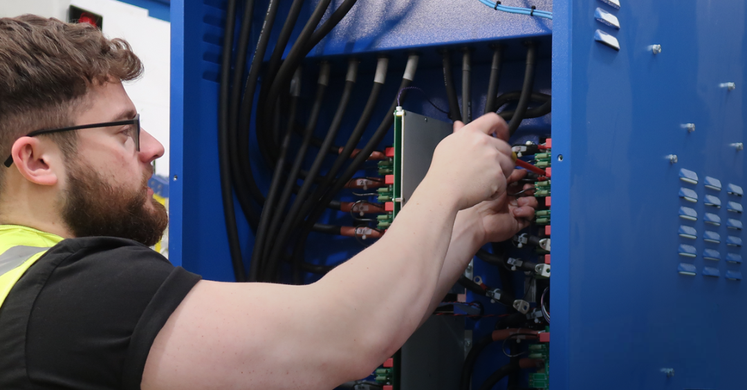 A Powerstar engineer installs wiring on a Voltage Optimisation unit during manufacture at the Powerstar facility.